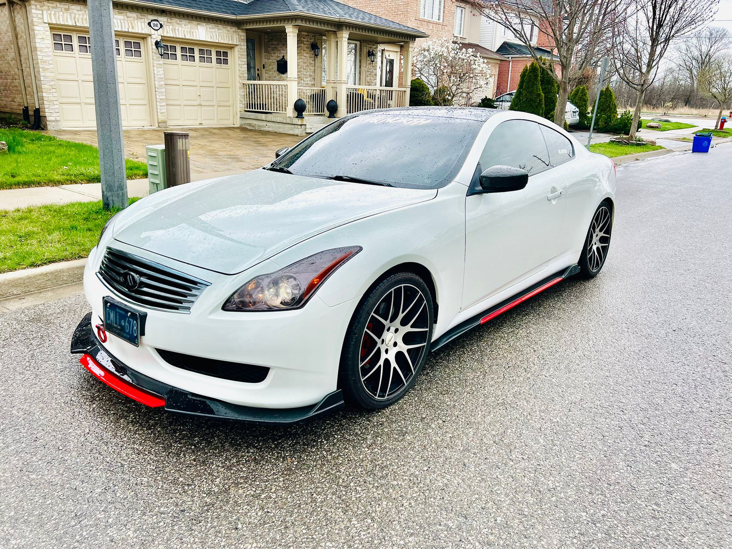 White coupe featuring universal gloss black side skirts with red trim, showcasing a bold, custom-styled street appearance – available at OneCarWorld.