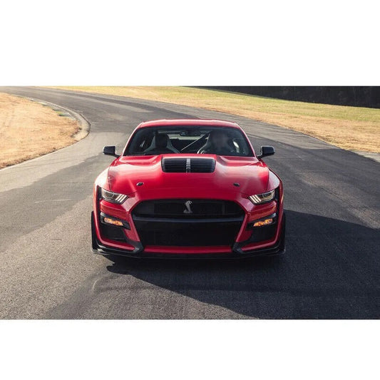 Red Ford Mustang with GT500-style aftermarket hood featuring heat extractor vent on a racetrack in Canada- OneCarWorld