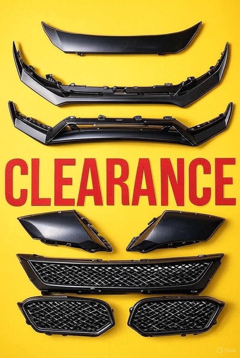 Clearance sale of automotive body parts at OneCarWorld, featuring black front bumper lips, grille inserts, and trim pieces on a yellow background.