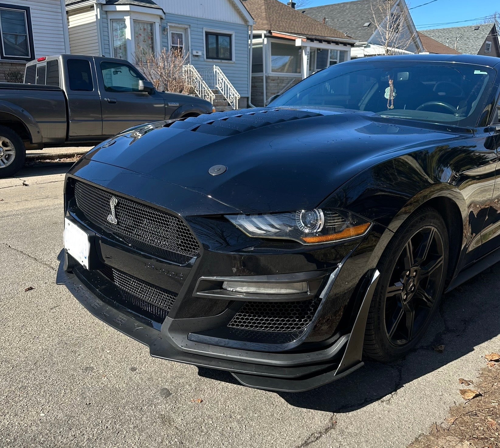 Close-up of a 2018–2022 Mustang with a Shelby GT500 style front bumper conversion installed, showcasing precision fitment and modern design.