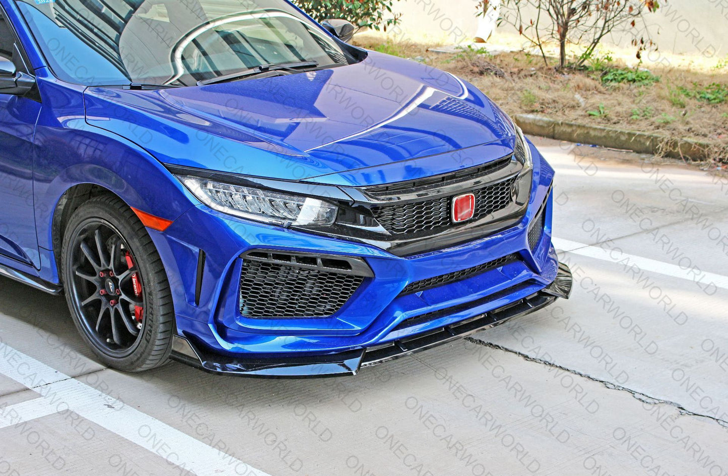 Blue Honda Civic with glossy RS style front bumper and black front lip installed, featuring mesh grilles and red emblem for a sporty, custom appearance – OneCarWorld