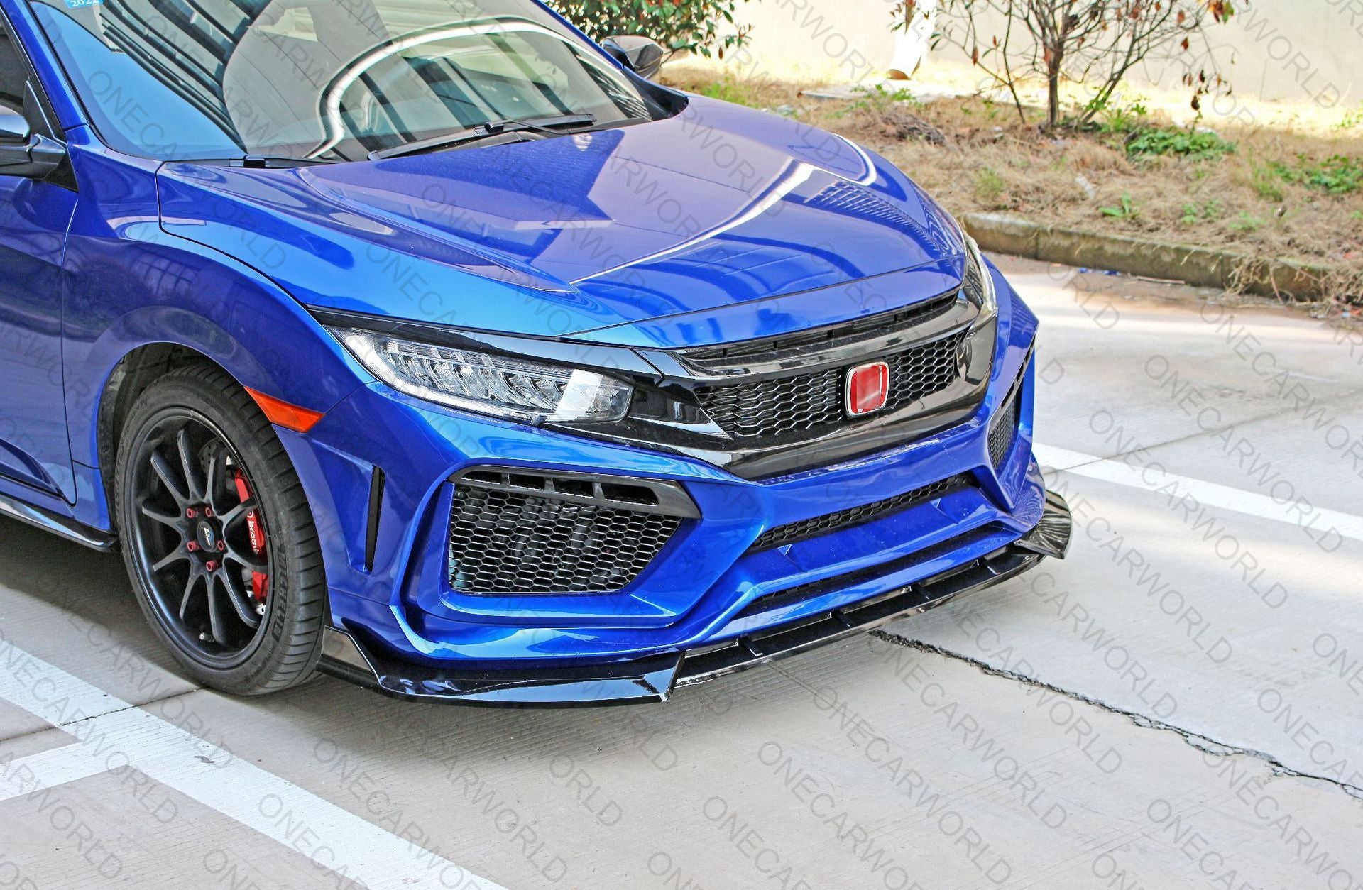 Blue Honda Civic with glossy RS style front bumper and black front lip installed, featuring mesh grilles and red emblem for a sporty, custom appearance – OneCarWorld