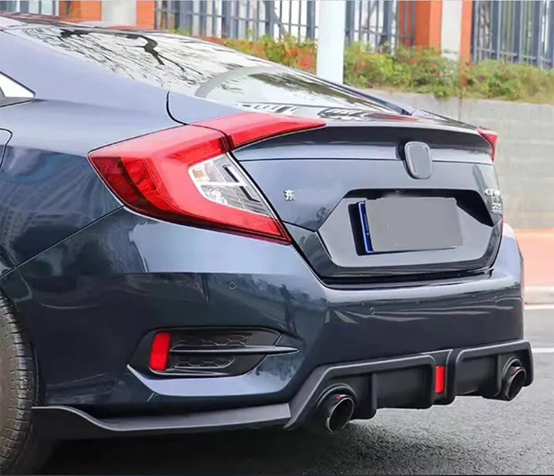 Glossy black rear diffuser spoiler lip with center light installed on a Honda Civic 10th Gen 2016–2019, enhancing sporty rear styling and airflow.