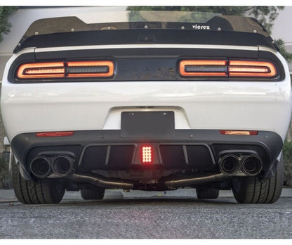 V1-style rear diffuser with integrated LED brake light installed on Dodge Challenger 2015–2022, featuring quad exhaust and aggressive rear styling.