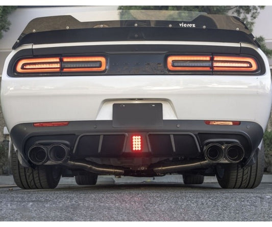 V1-style rear diffuser with integrated LED brake light installed on Dodge Challenger 2015–2022, featuring quad exhaust and aggressive rear styling.
