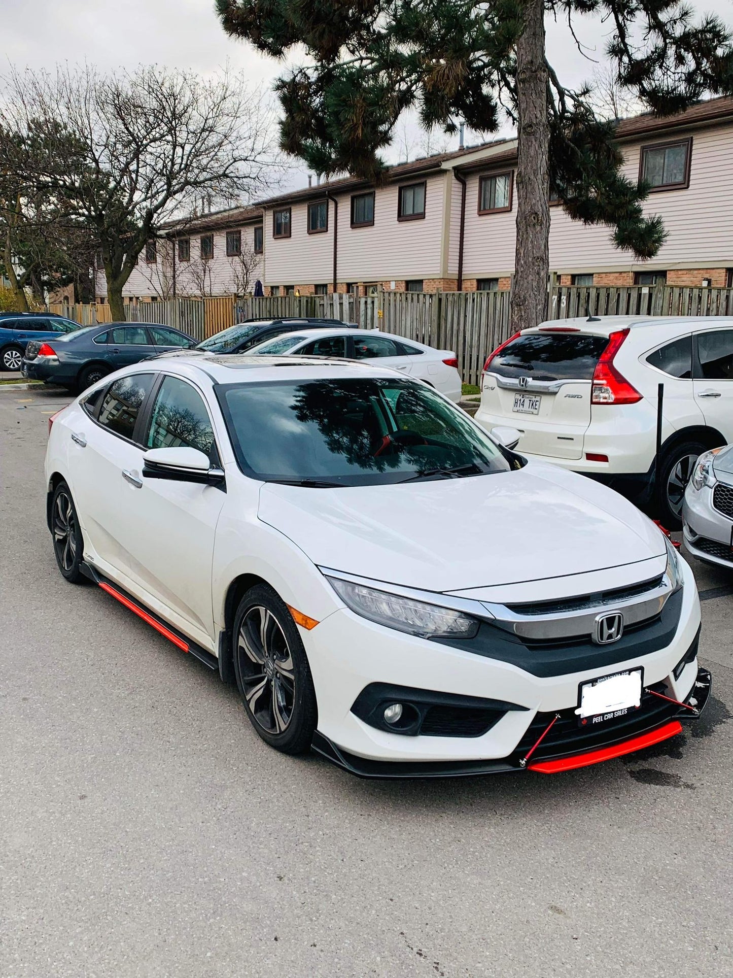 Honda Civic fitted with universal gloss black side skirts featuring red color trim, showcasing aggressive styling and custom fitment – available at OneCarWorld.